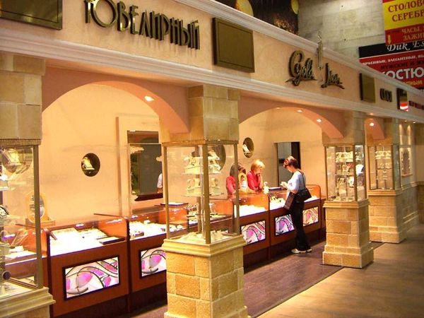 Jewelry boutique with stone columns, glass counters and a central island vitrine.