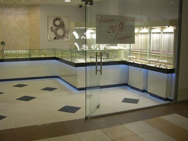 Jewelry salon behind a glass entrance, with corner counters and wall-mounted display furniture.