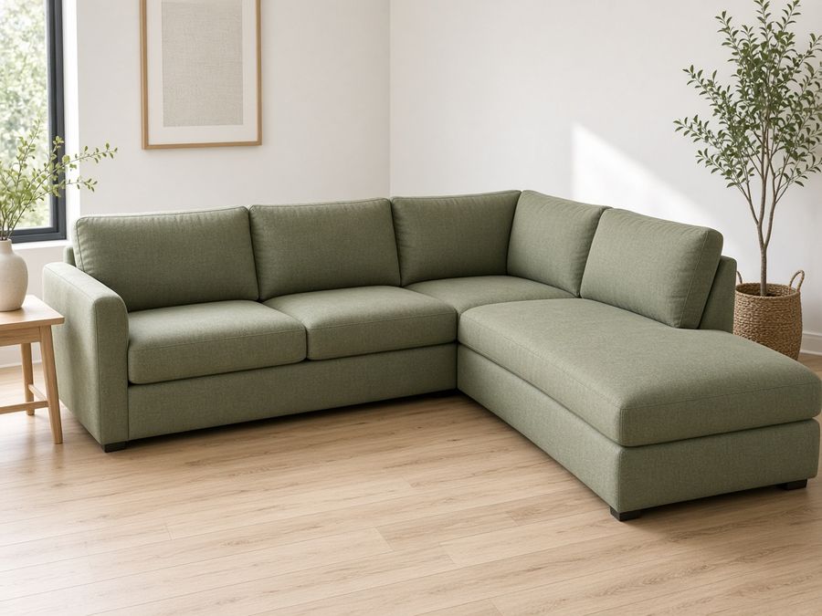 A sage linen L-shaped corner sectional with a chaise in a bright living room.