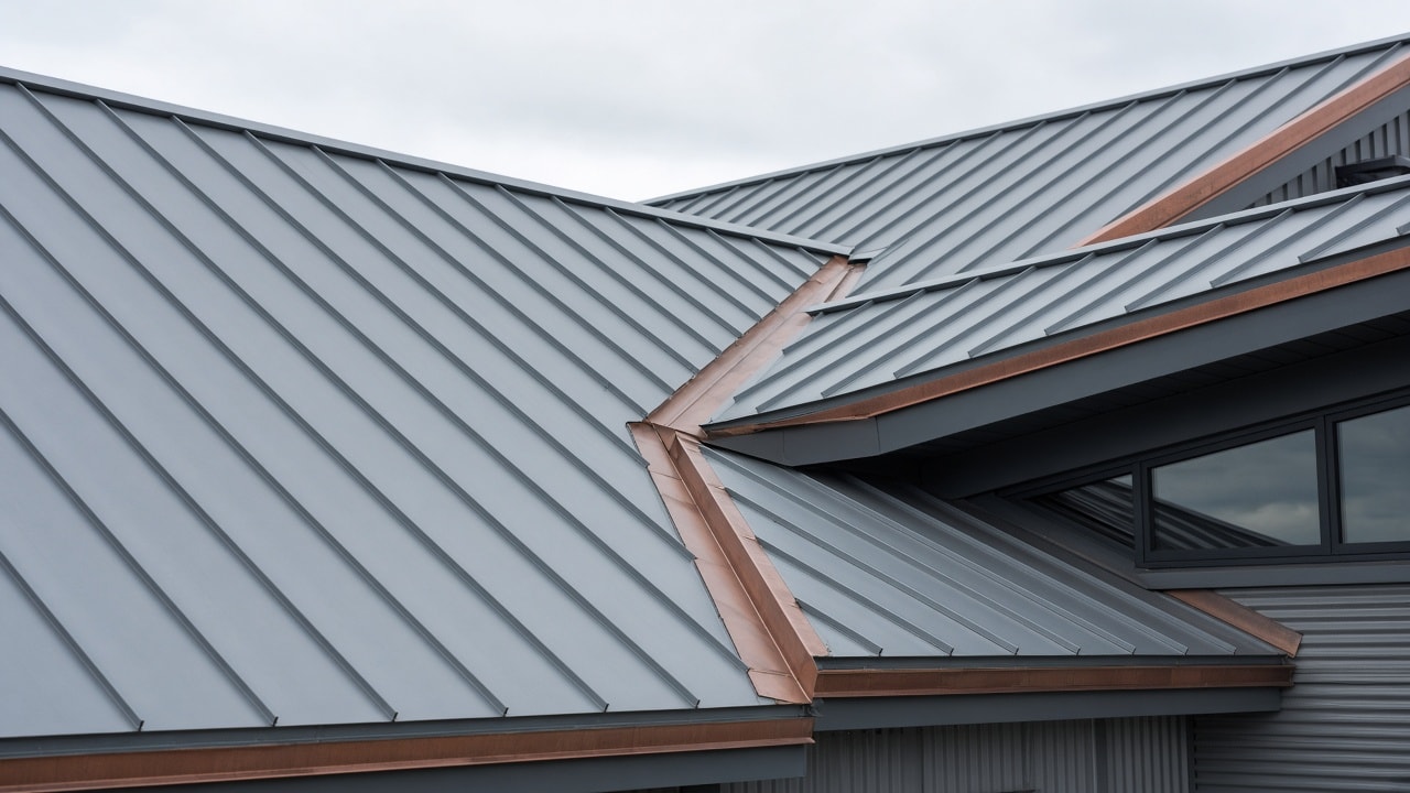 Standing-seam metal roof on a contemporary commercial building, with valleys, ridges and metal flashing.