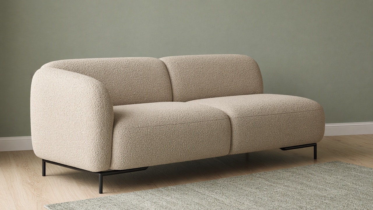 A compact two-seat sofa in sand boucle with rounded arms and thin black legs.